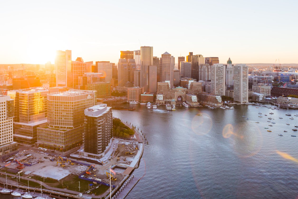 Aerial shot of East Boston Waterfront at sunset, showing different commercial and residential real estate properties.