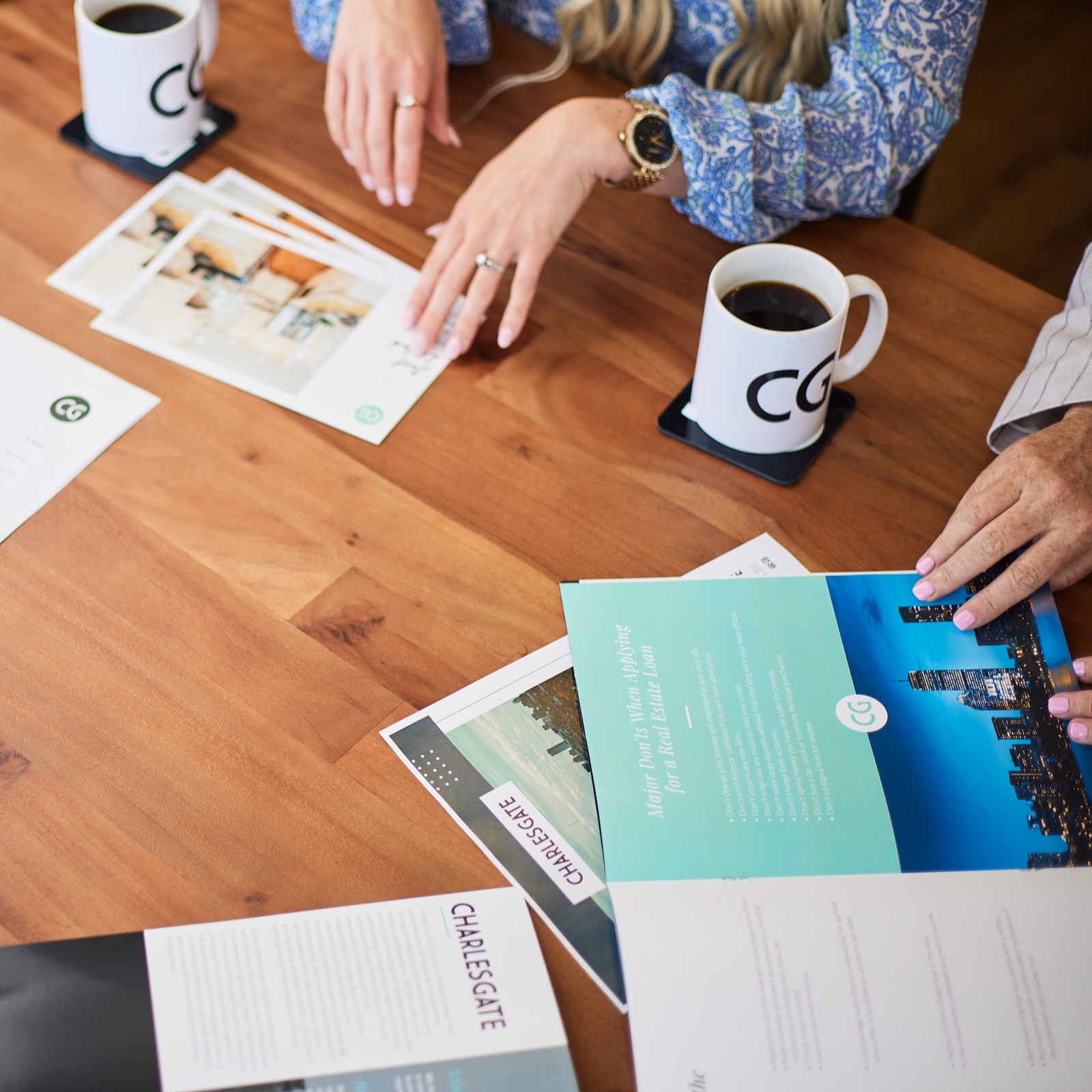 CHARLESGATE marketing collateral, cups of coffee, and agent hands