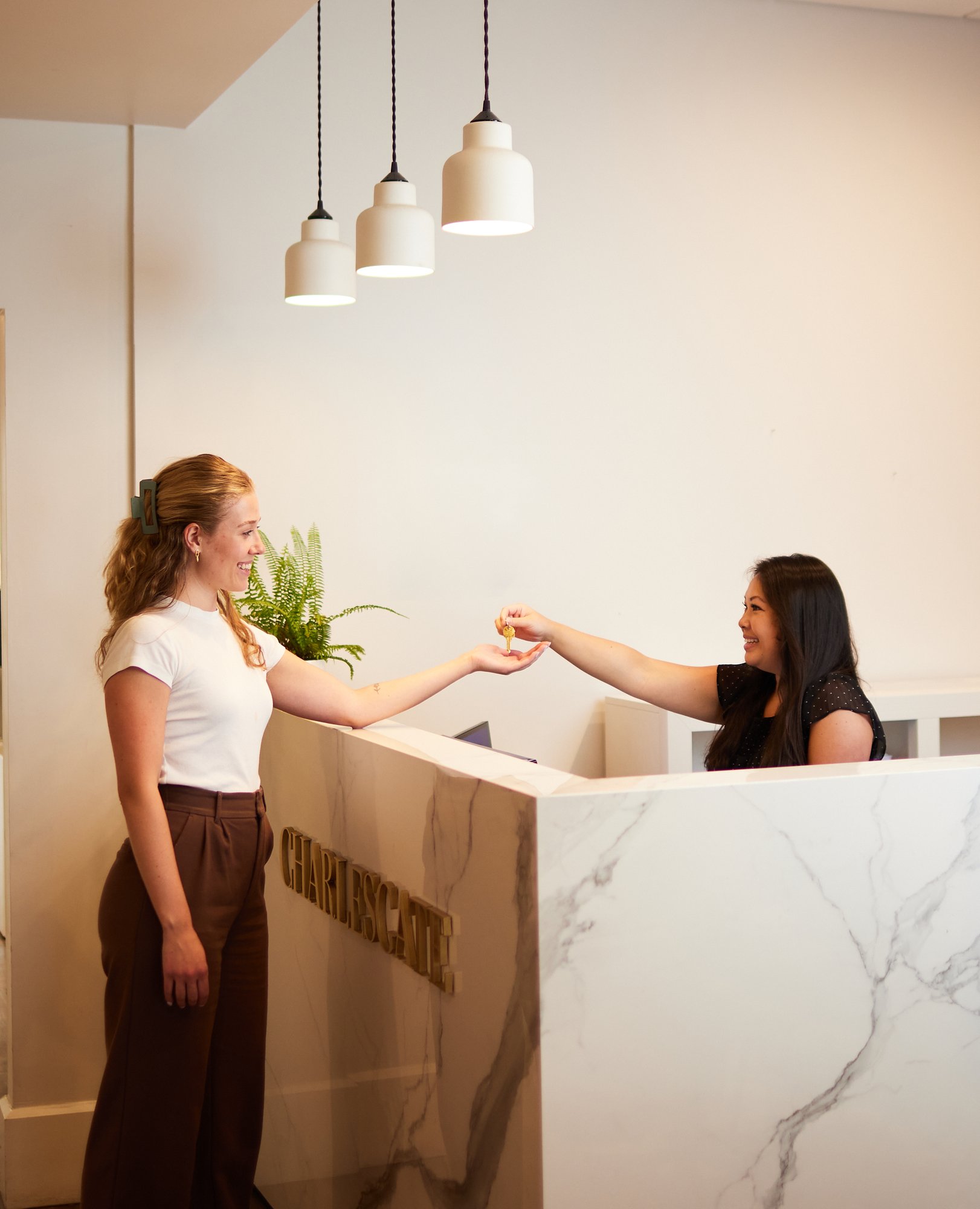 CHARLESGATE front desk woman handing keys to another woman